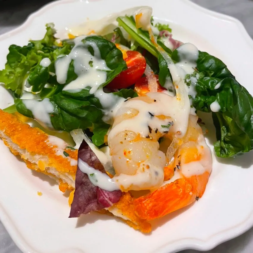 Salad drizzled with ranch dressing