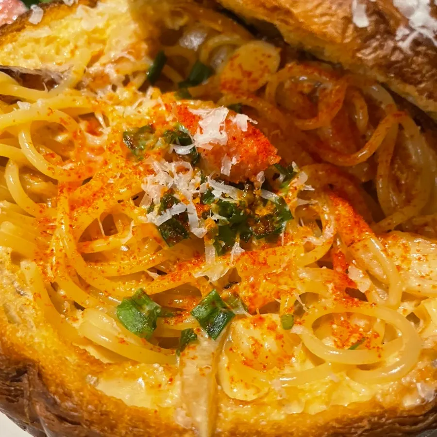 Pasta noodles coated in myeongnan cream sauce