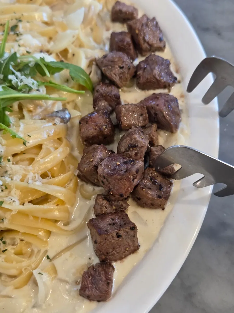 Steak cream pasta coated in thick sauce