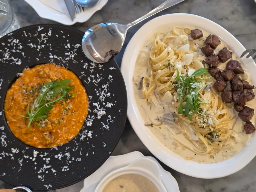 Pasta plated on a clean table setting