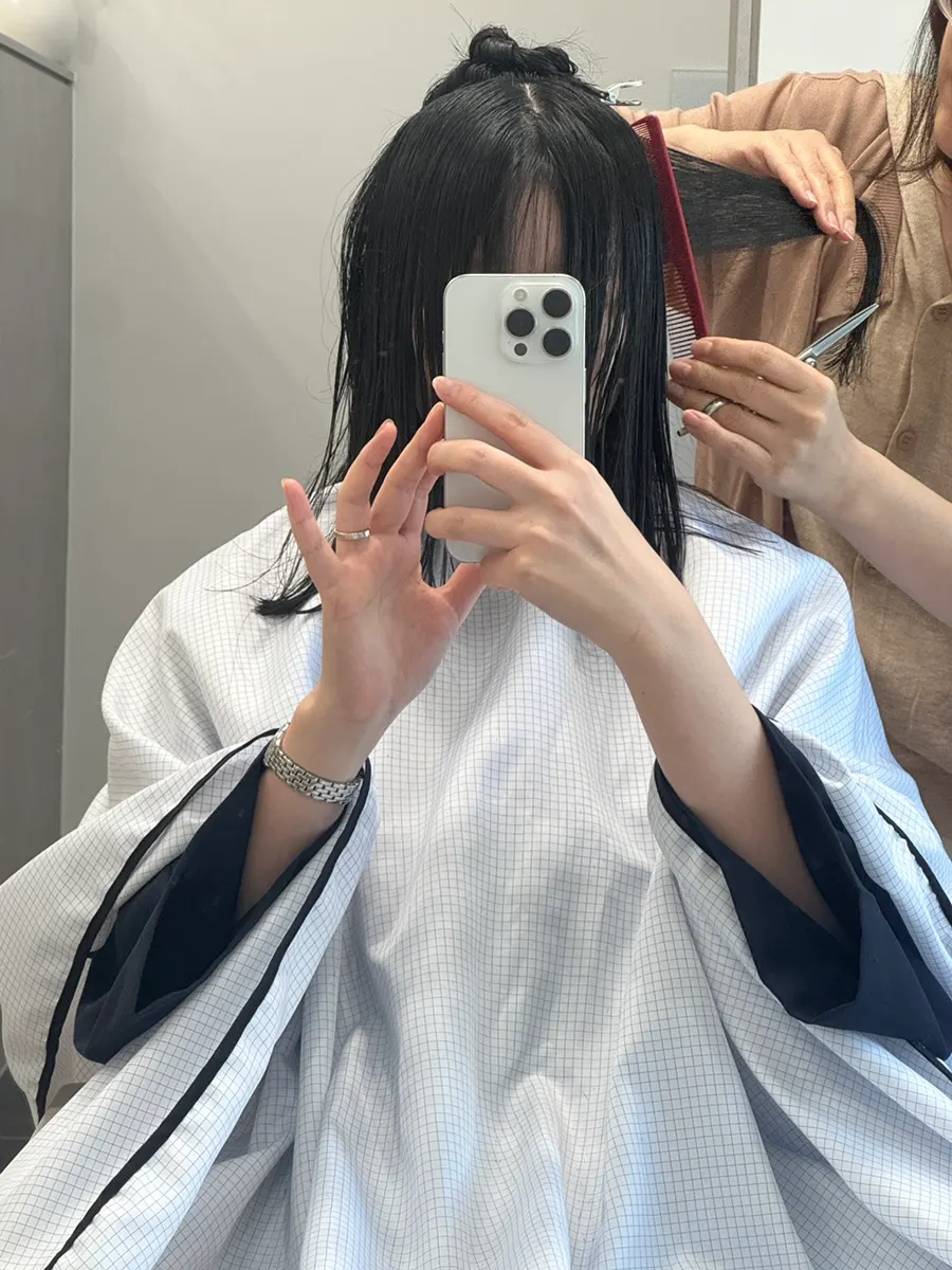 Wearing a salon gown before the haircut