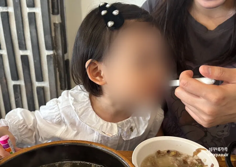A child's bowl with rice mixed into galbitang broth
