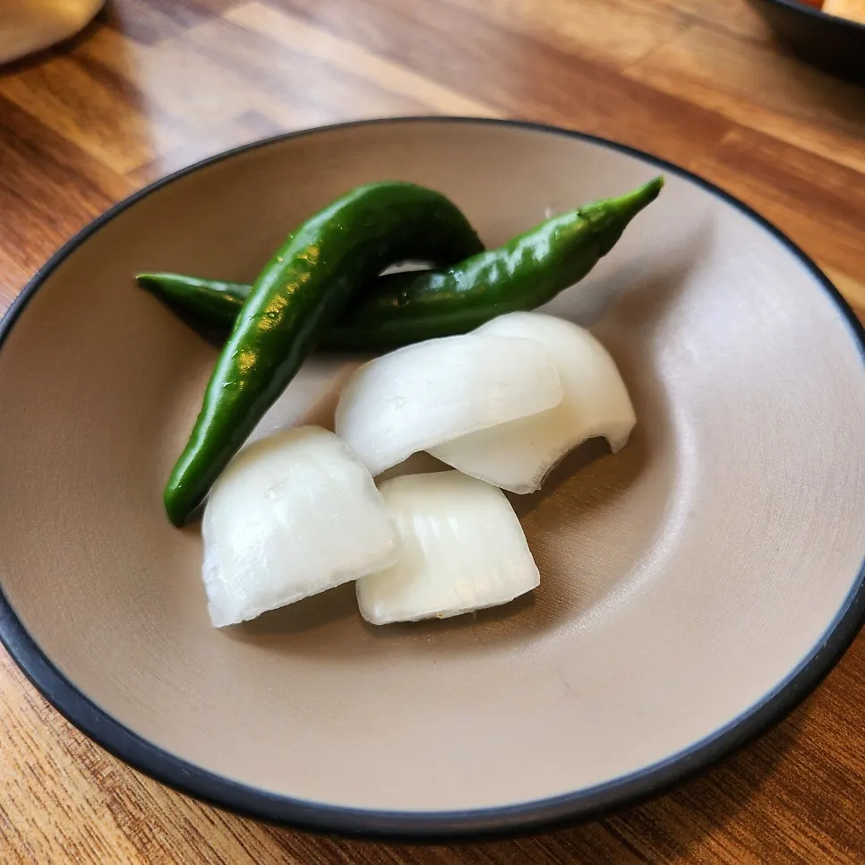 Peppers, onions, and ssamjang side dishes