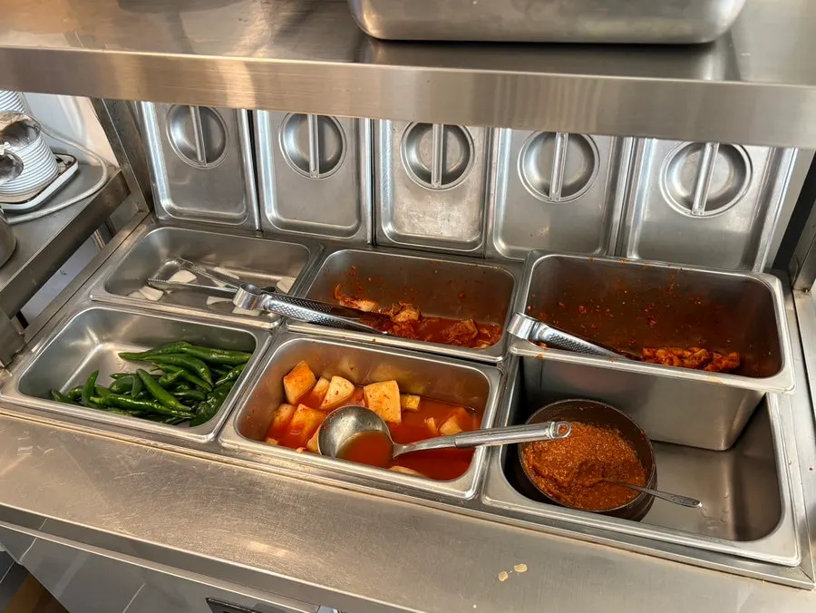 Self-serve bar with kimchi and rice