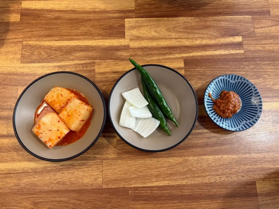 Basic side dishes of kkakdugi, peppers, onion, and sauce