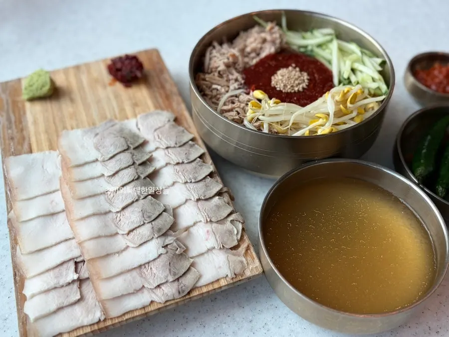 Full spread of bibim noodles and dombe naengsuyuk