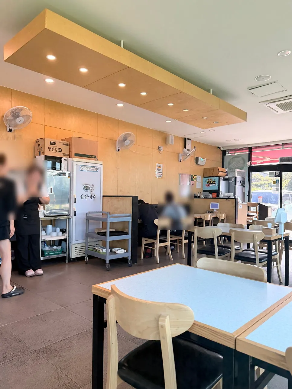 Restaurant interior with sea views through full-height windows