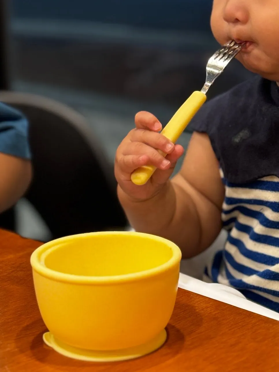 Kids' tableware and baby chair set at the table