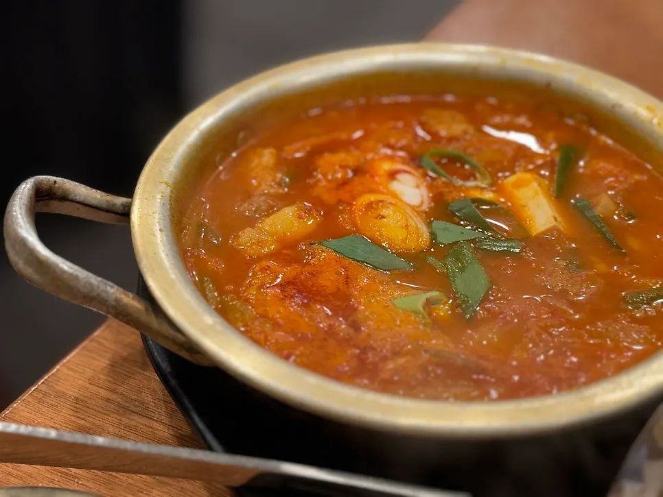 24-hour aged kimchi jjigae bubbling hot