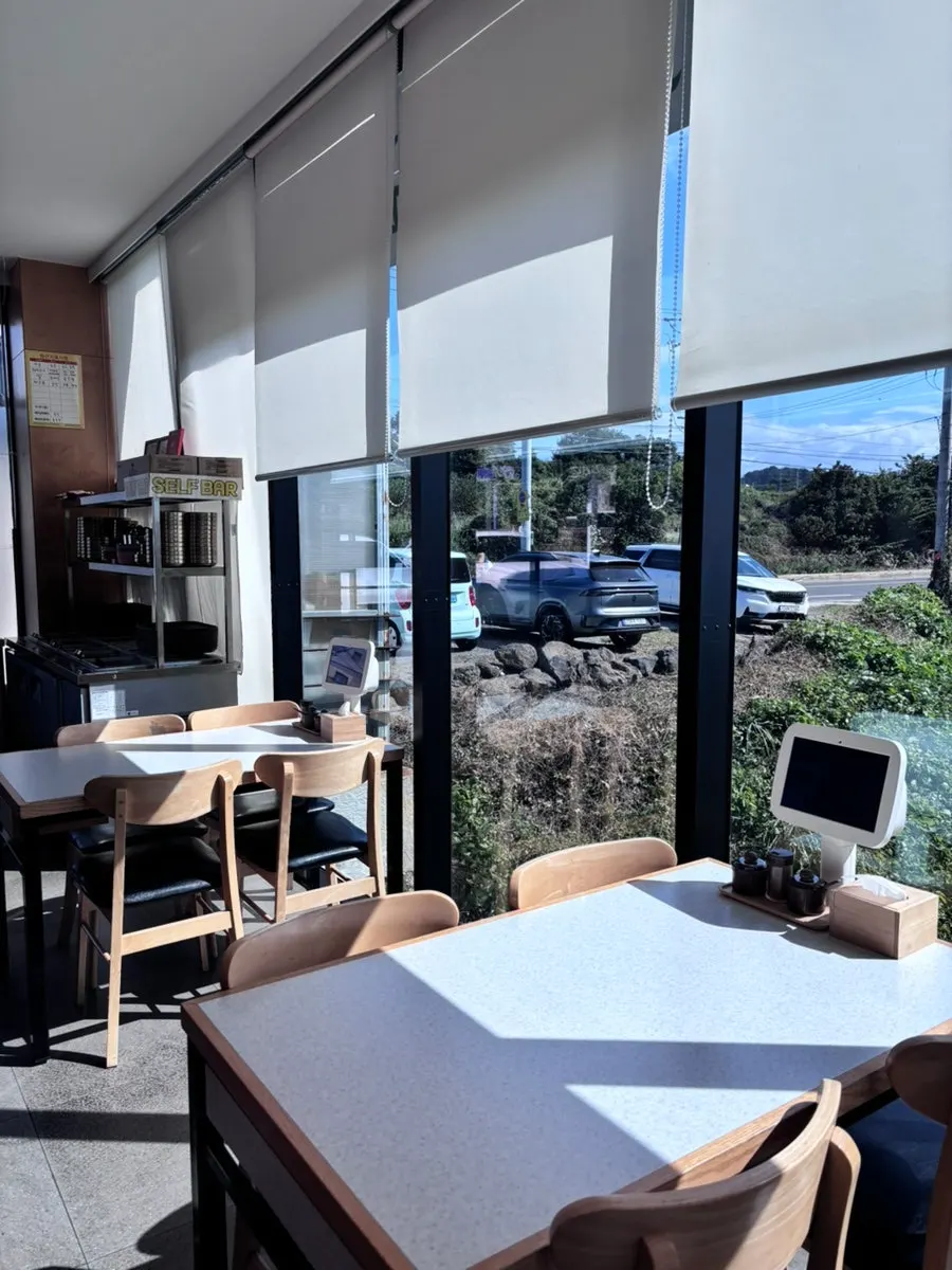 Interior of Handam Guksu with ocean visible through floor-to-ceiling windows