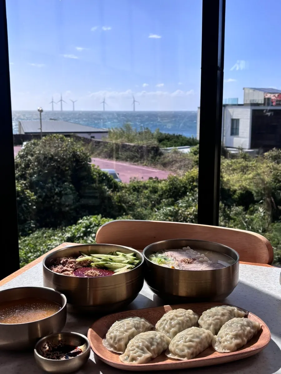Gogigguksu and bibim guksu placed by the ocean-view window