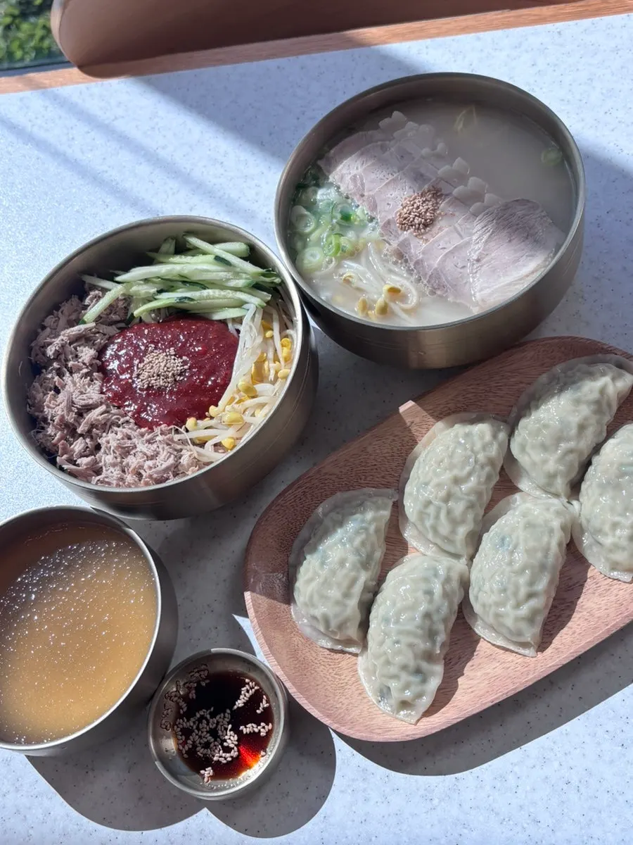 A bowl of noodles served with self-serve side dishes