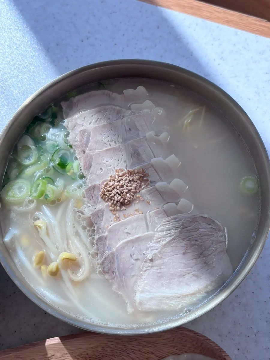 Chewy noodles lifted with chopsticks