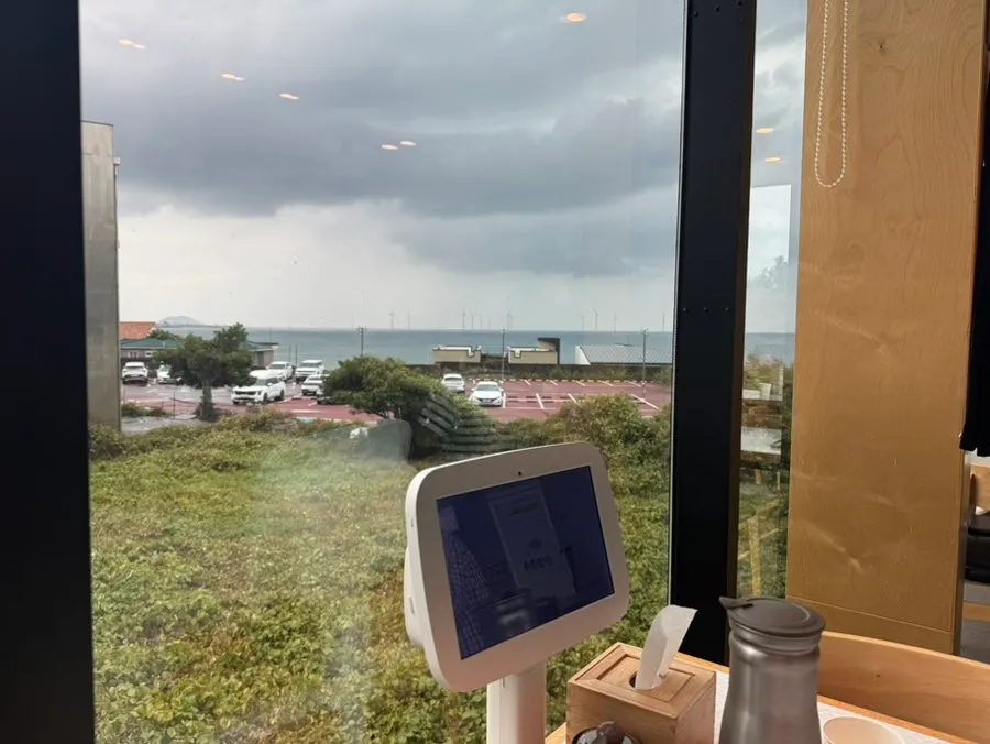 Ocean-view seating with Aewol's sea visible through the window