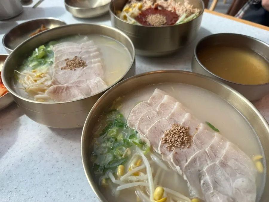 Rich bone-broth pork noodles served at the table