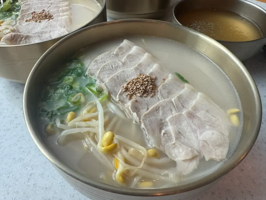 Close-up of pork noodles piled generously with meat
