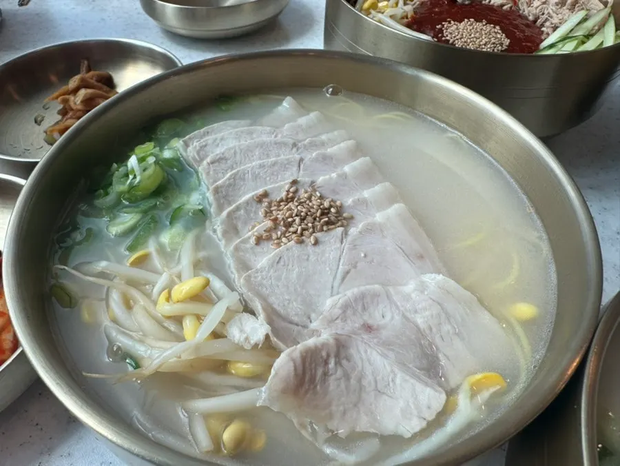 The generous portion of a bowl of pork noodles