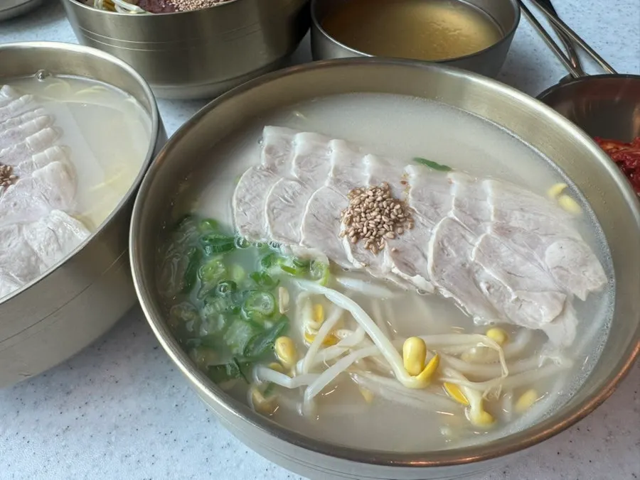 Noodles and meat lifted with chopsticks