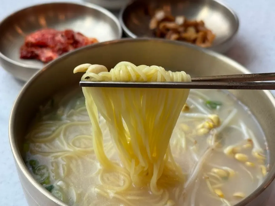 Delicate noodles lifted with chopsticks