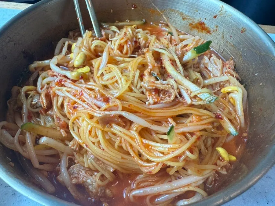 Bibim noodles topped with special sauce and Jeju pork