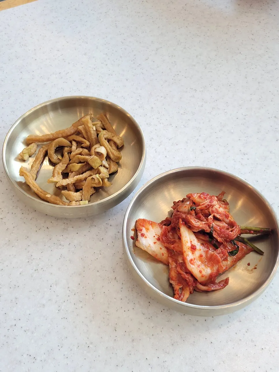 Plate of domestic kimchi and pickled radish strips