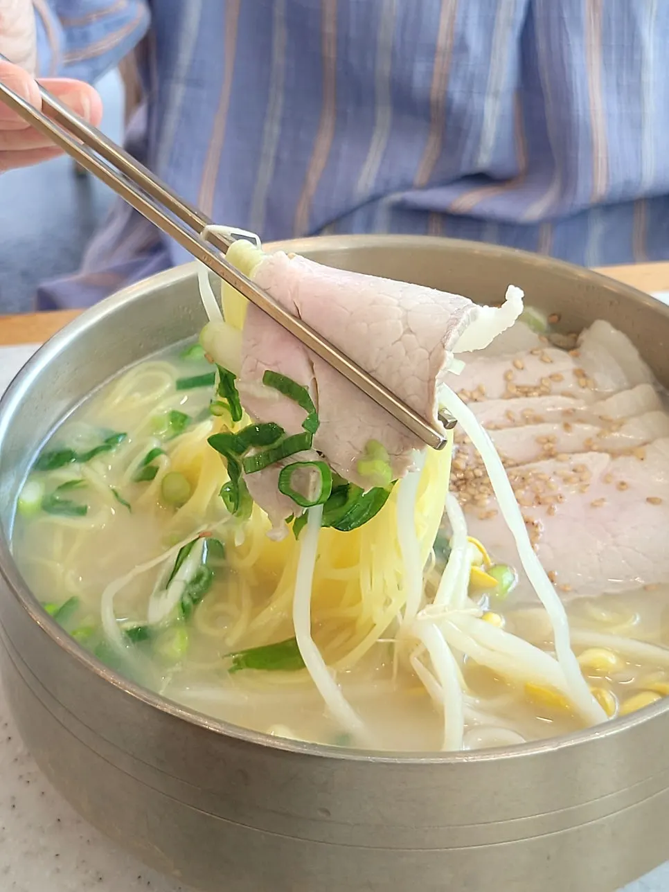 Chopsticks lifting pork noodles