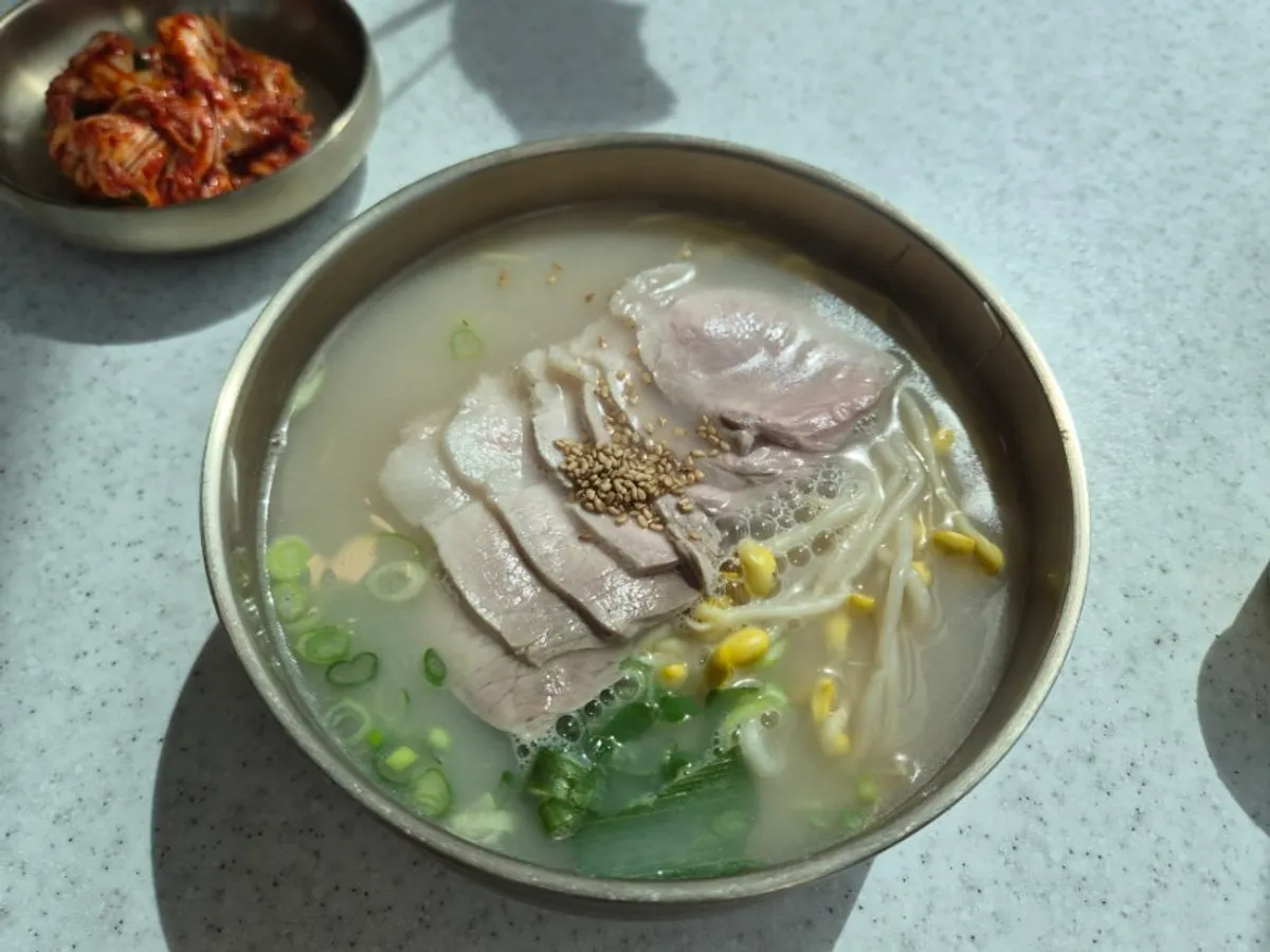 A bowl of Handam Guksu's bone-broth pork noodle soup