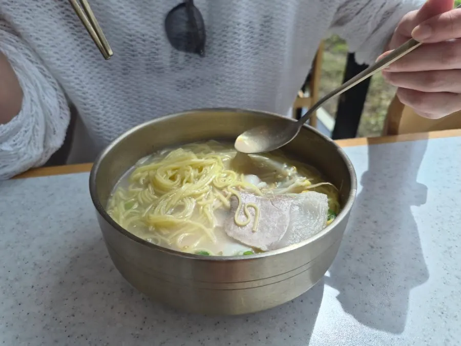 Window-side ocean-view seat at Handam Guksu after finishing the meal