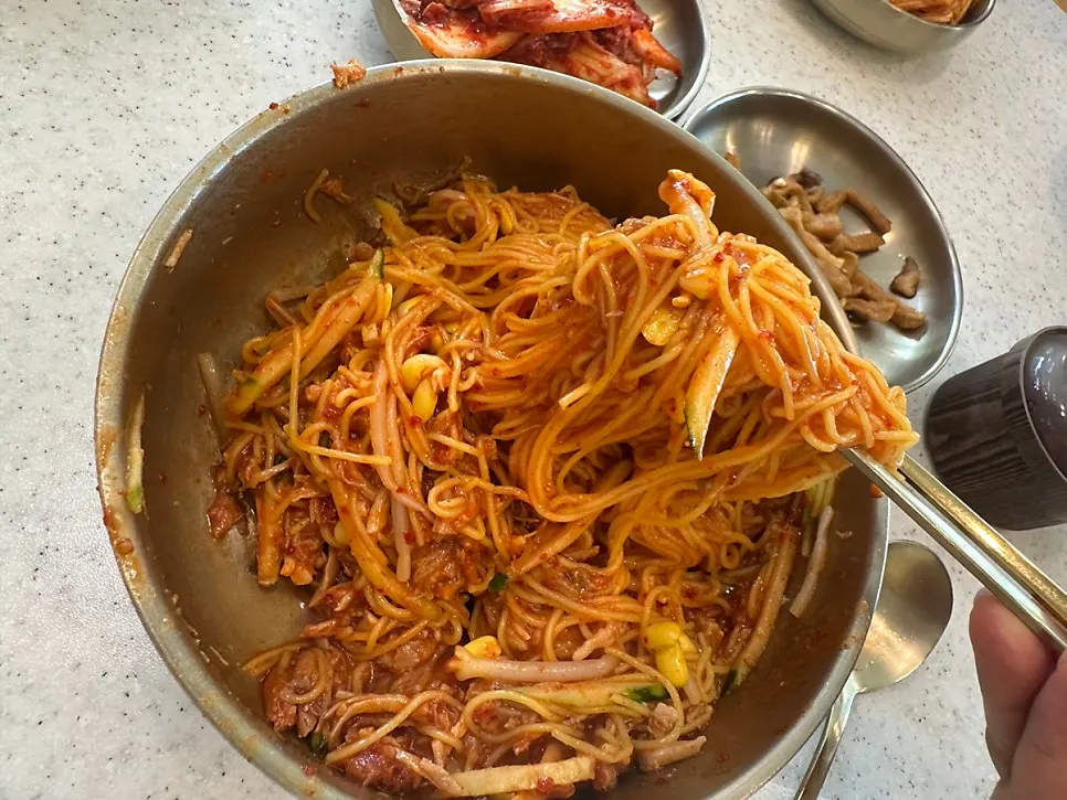 Bibim noodles and tteokgalbi laid out on the table
