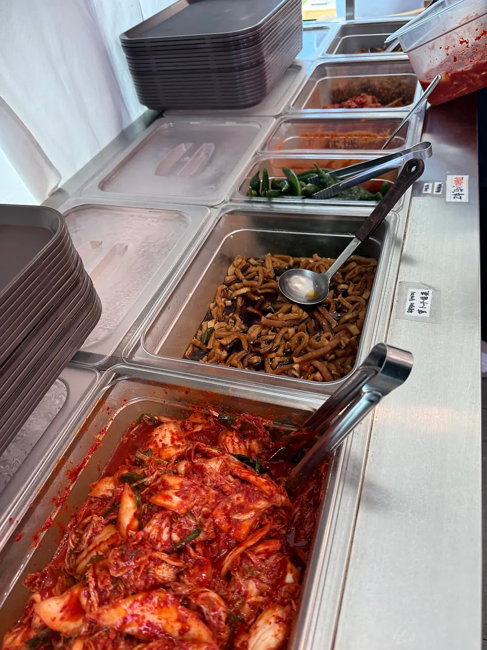 Self-serve bar with fresh kimchi and dried radish strips