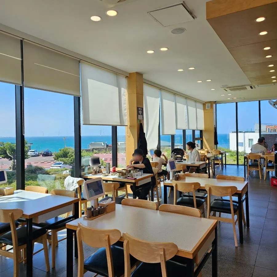 Restaurant with ocean-view window seating at every table and a self-serve bar