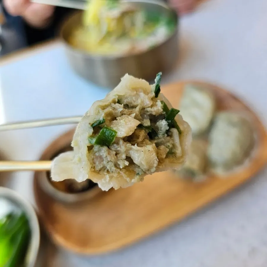 A plate of meat dumplings packed full inside