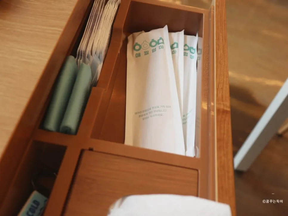 Table drawer with spoons, apron, and wet wipes