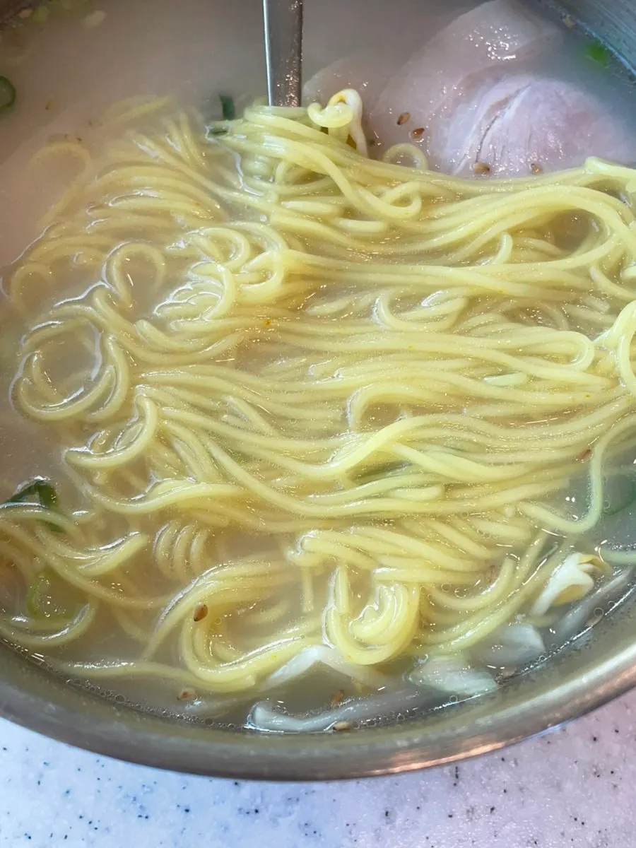 Table setting with beef-bone pork noodles and dombe naeng suyuk