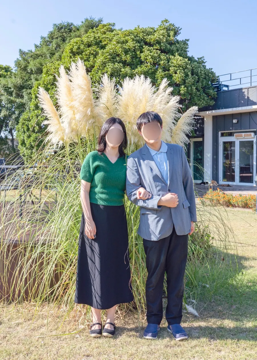 Retouched couple snap with a silver grass field background