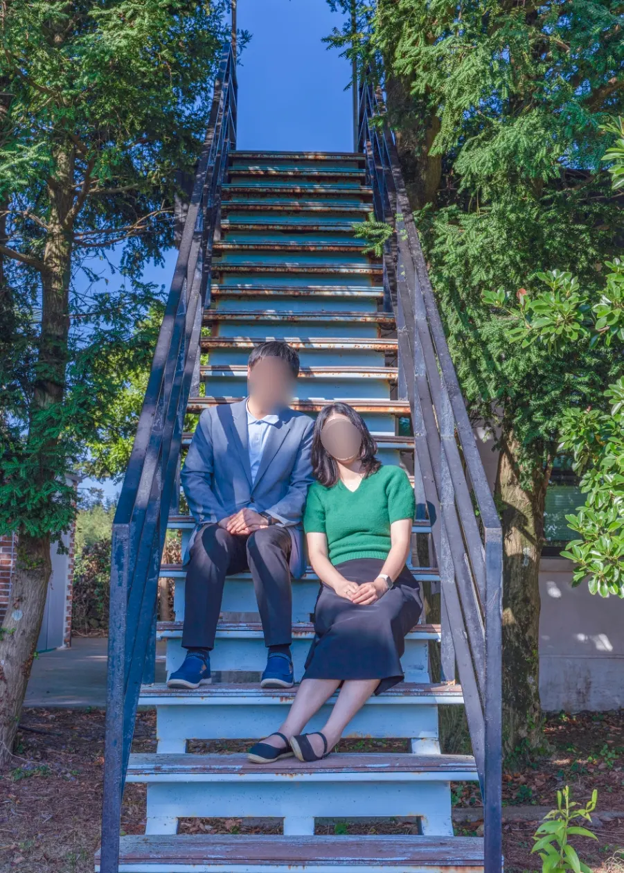 Retouched couple snap taken on the teal-colored stairs