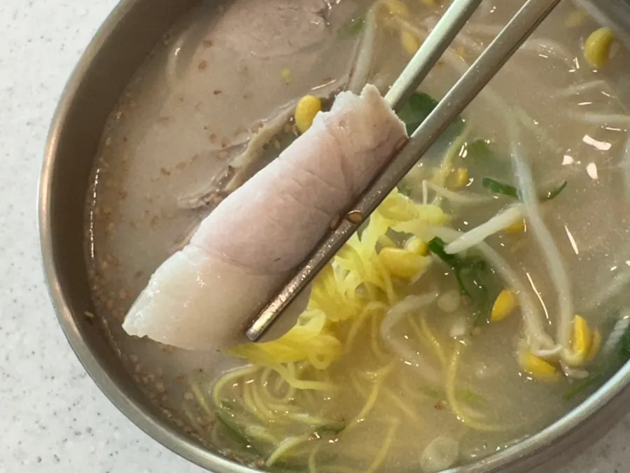 Noodles lifted up from the pork noodle soup