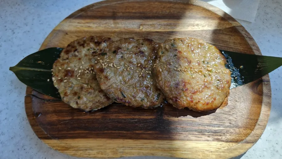 Handmade pork tteokgalbi on a wooden cutting board