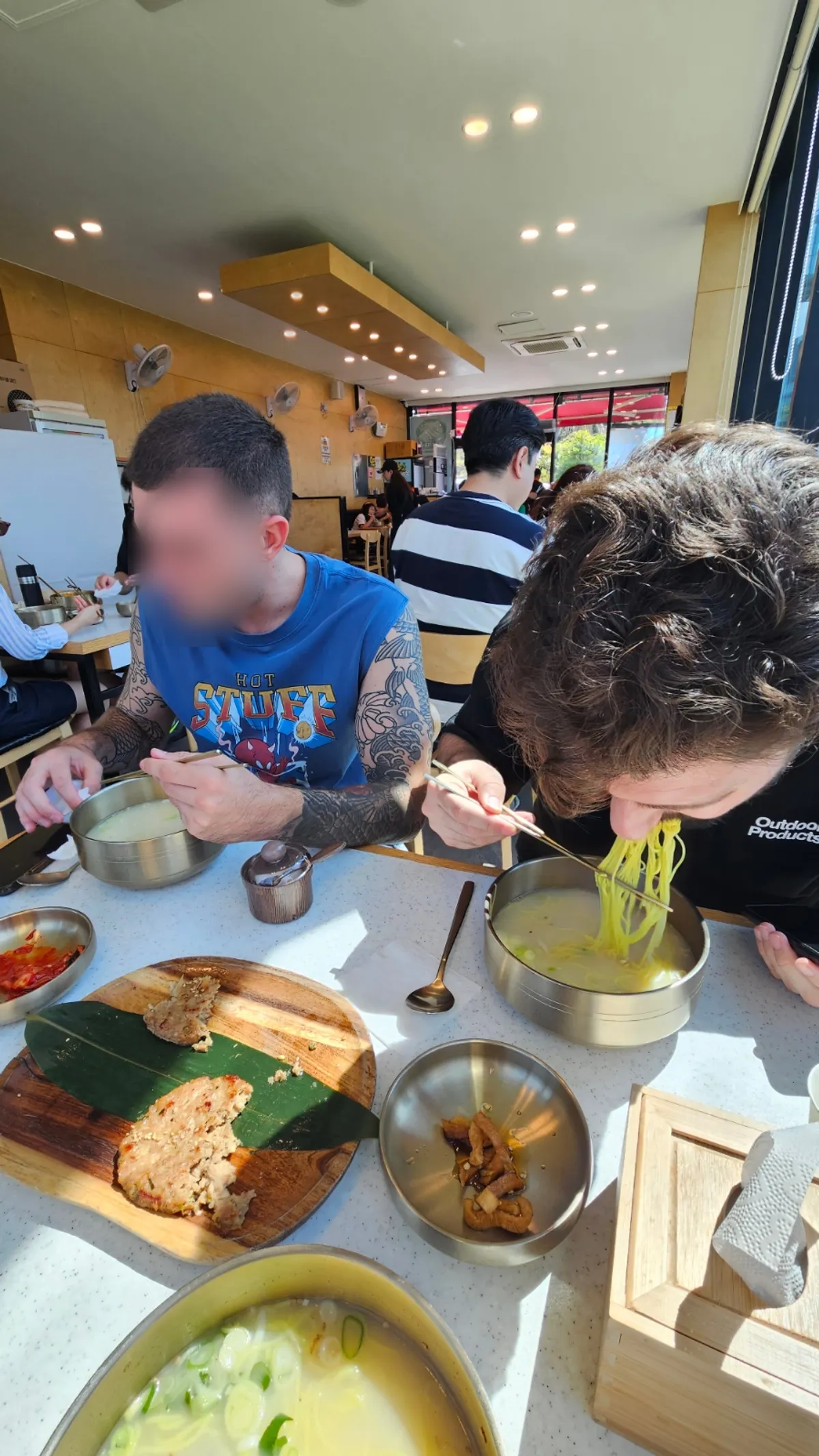 Bone-broth pork noodle soup served in a brass bowl