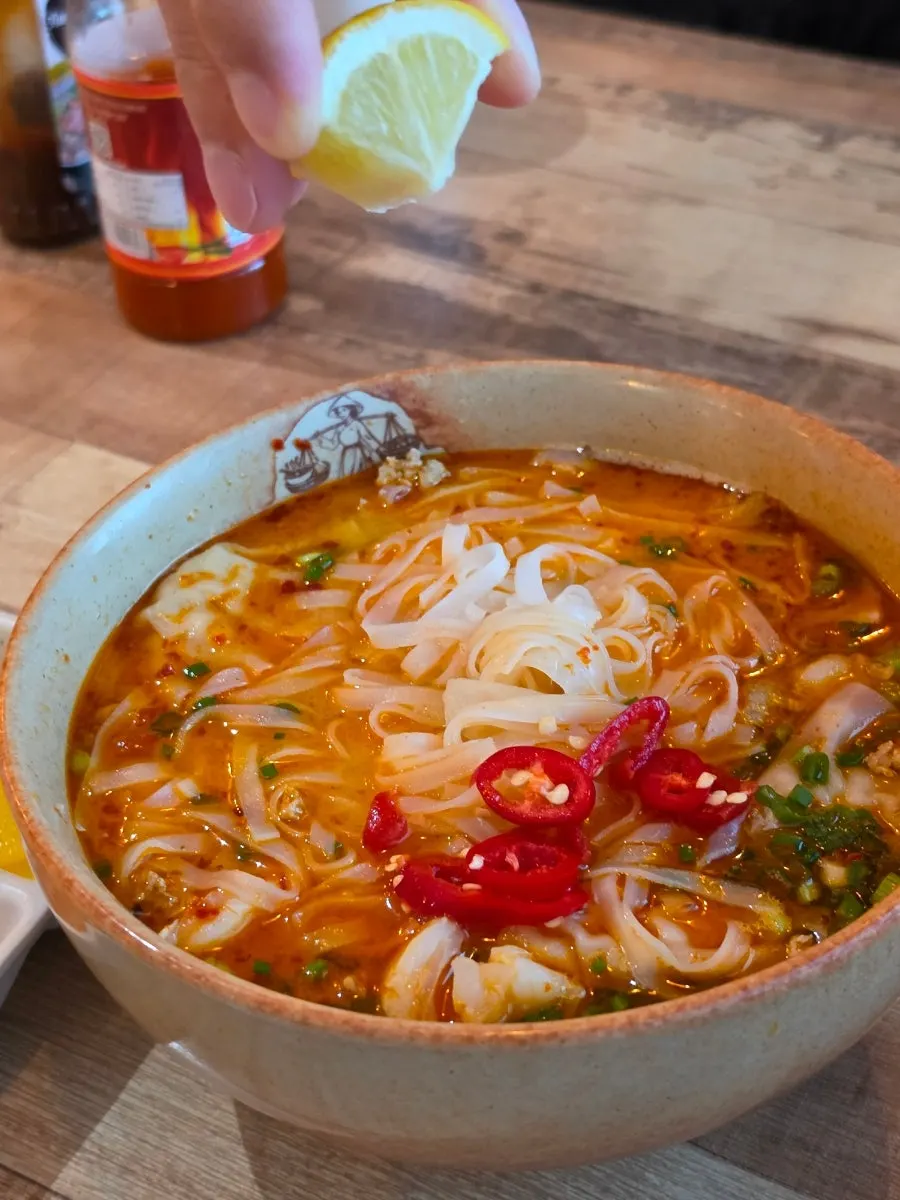 Tom yum pho broth loaded with toppings