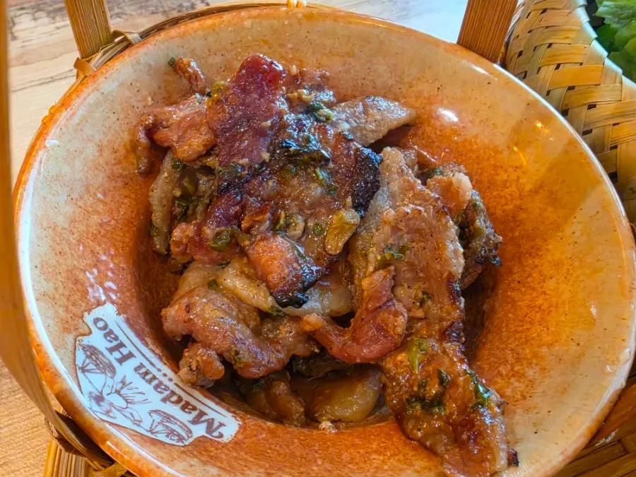 Charcoal-grilled pork sitting in bun cha sauce
