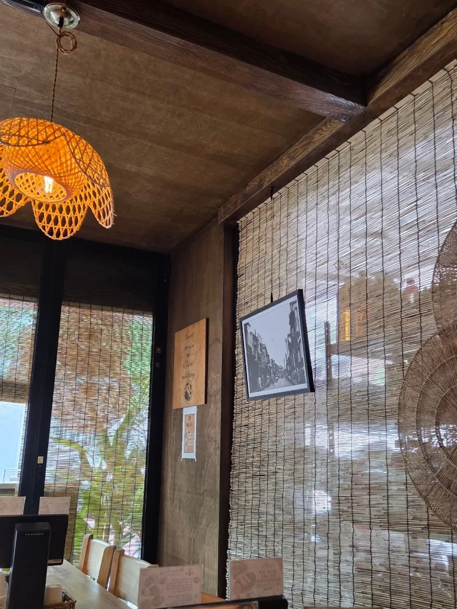Vietnamese-style interior with rattan lighting and wooden tables