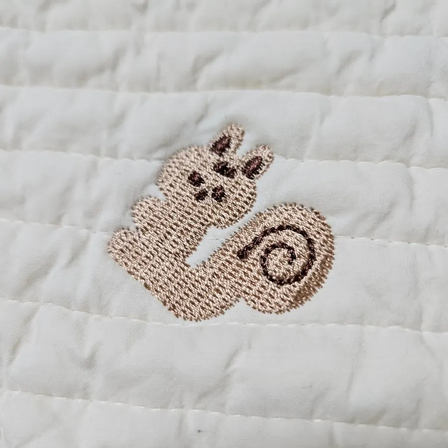 Pillow cover embroidered with acorns and squirrels
