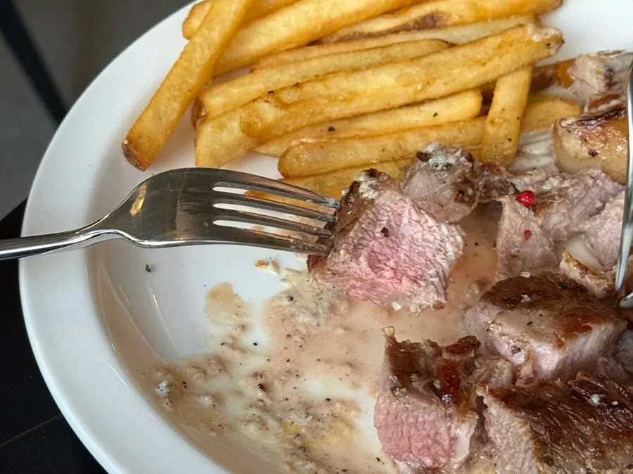 Cross-section of a moist, well-cooked pork shoulder steak