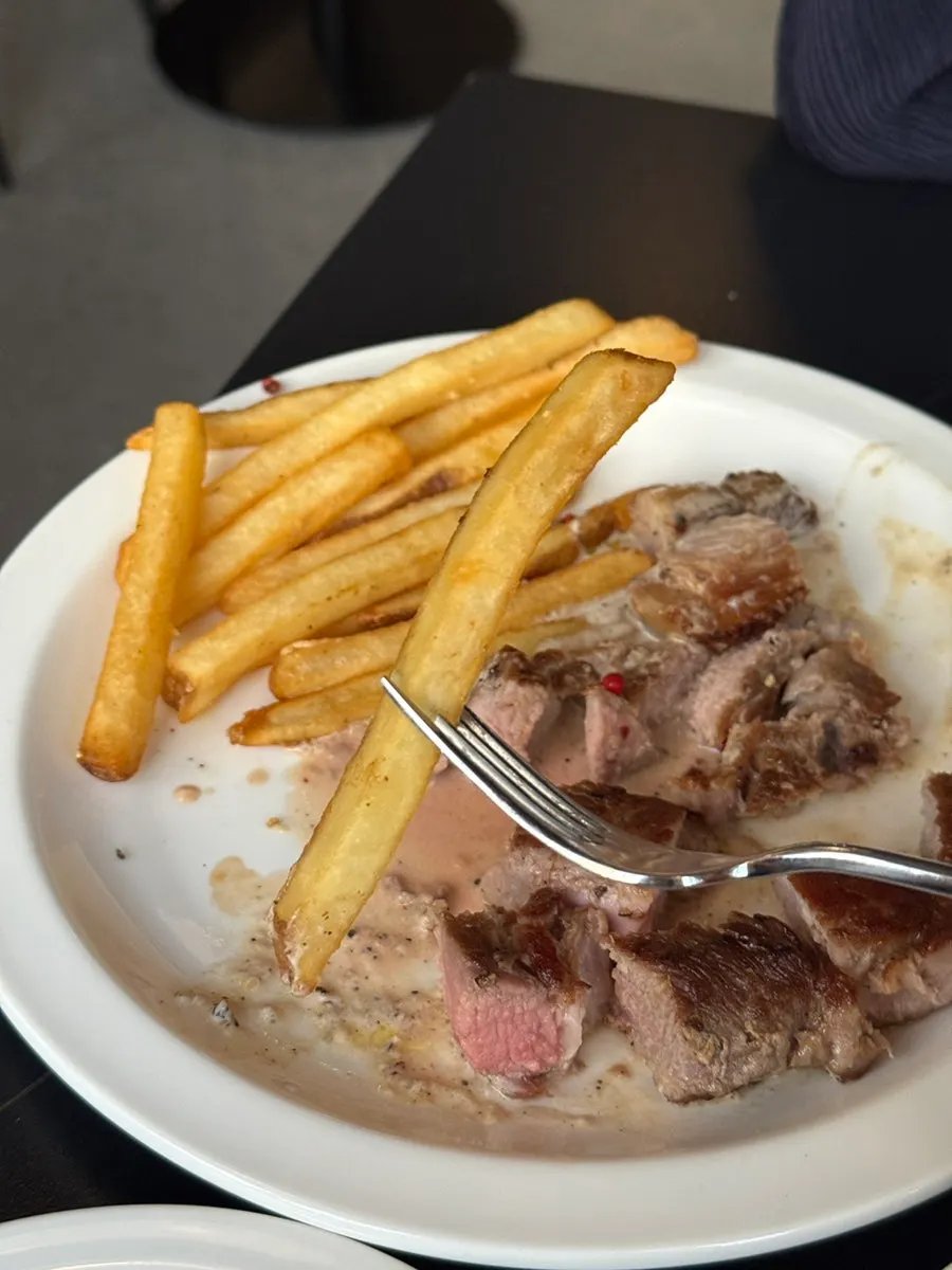 Dipping fries into the steak sauce
