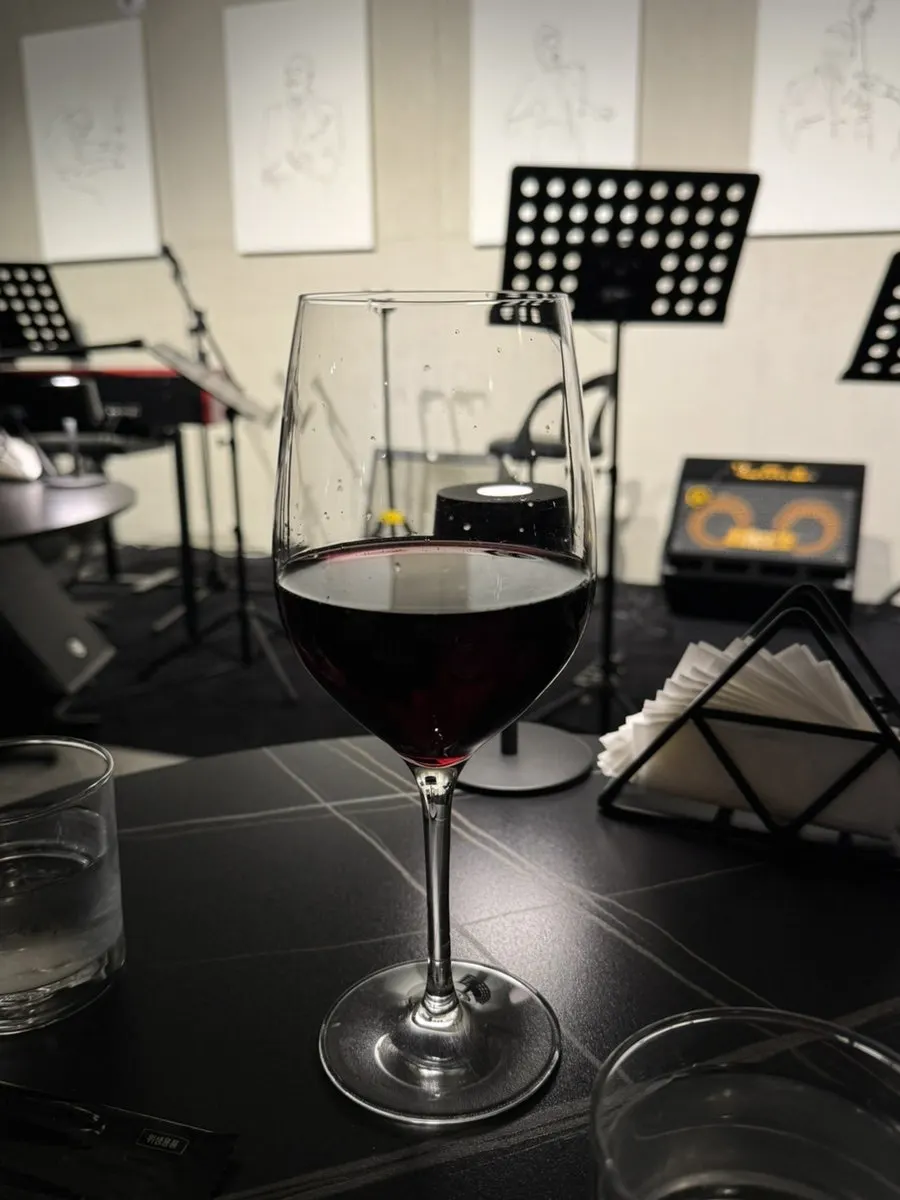 A glass of red wine ordered by the glass