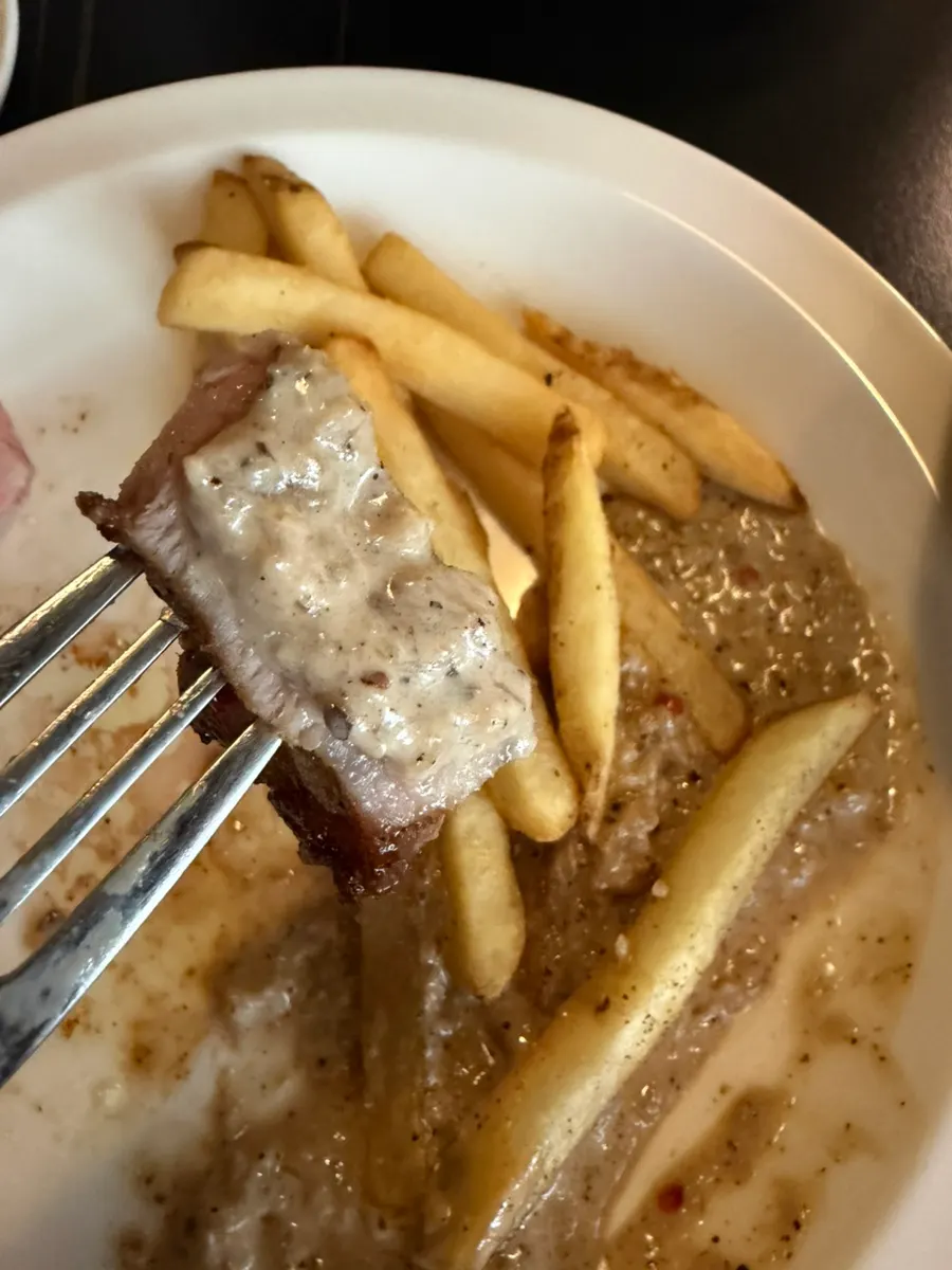 Pork neck steak served with peppercorn sauce