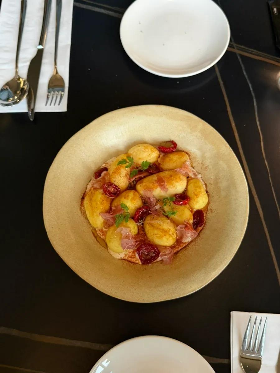 A plate of prosciutto potato salad