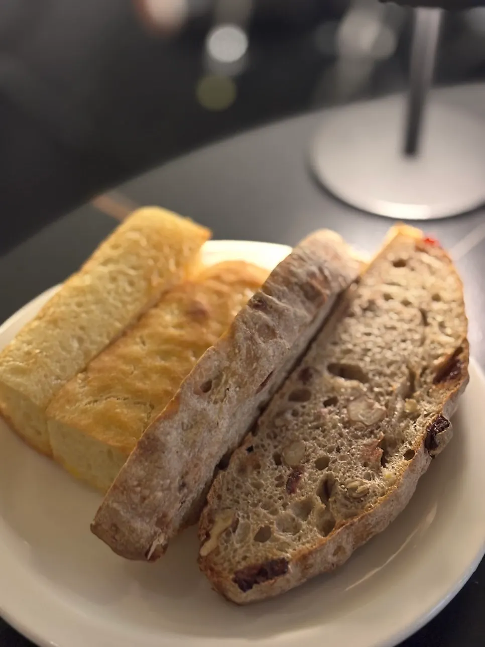 A plate of house-made focaccia, ciabatta and campagne