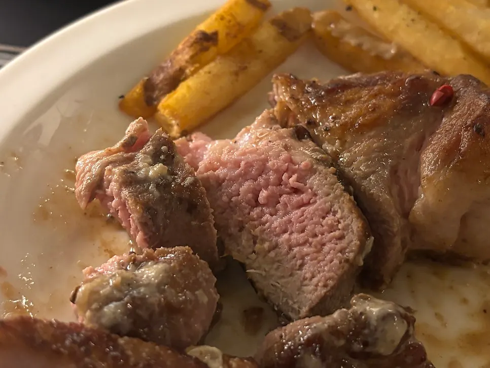 Sous-vide pork shoulder steak served with fries